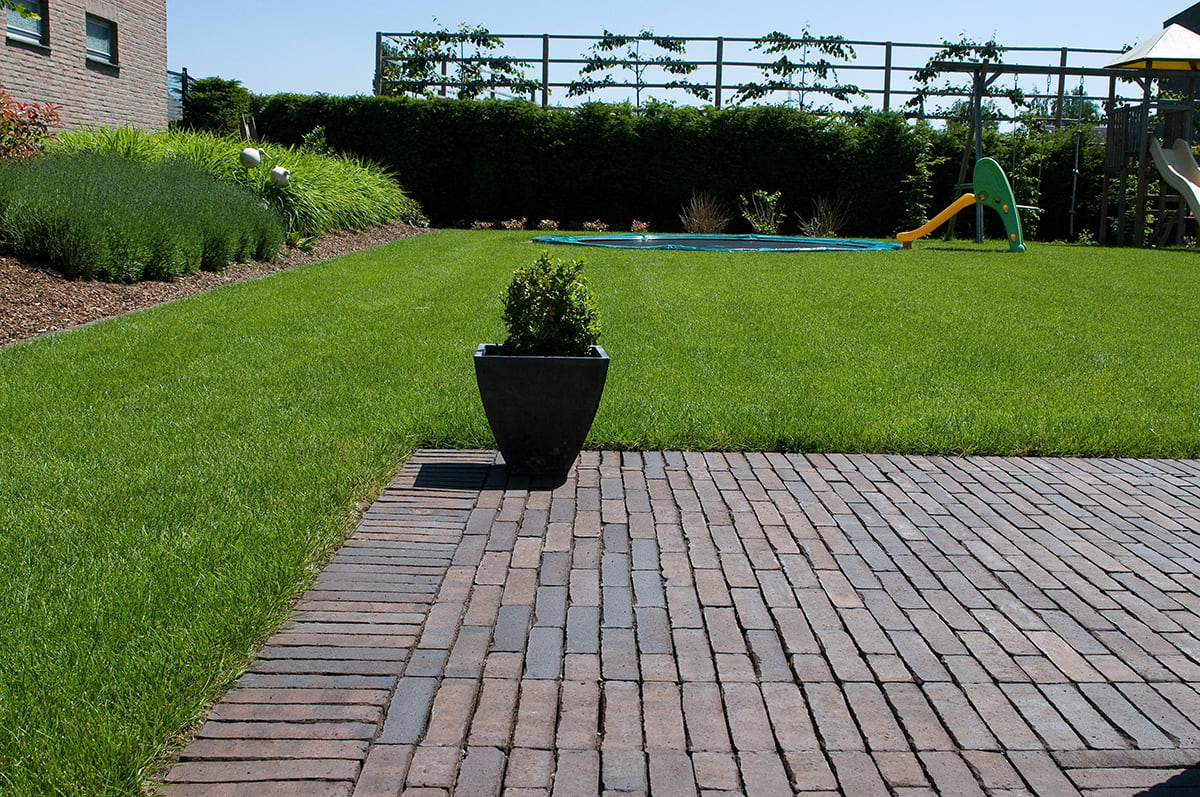 Edge of a pool with grey pavers and flagstone.