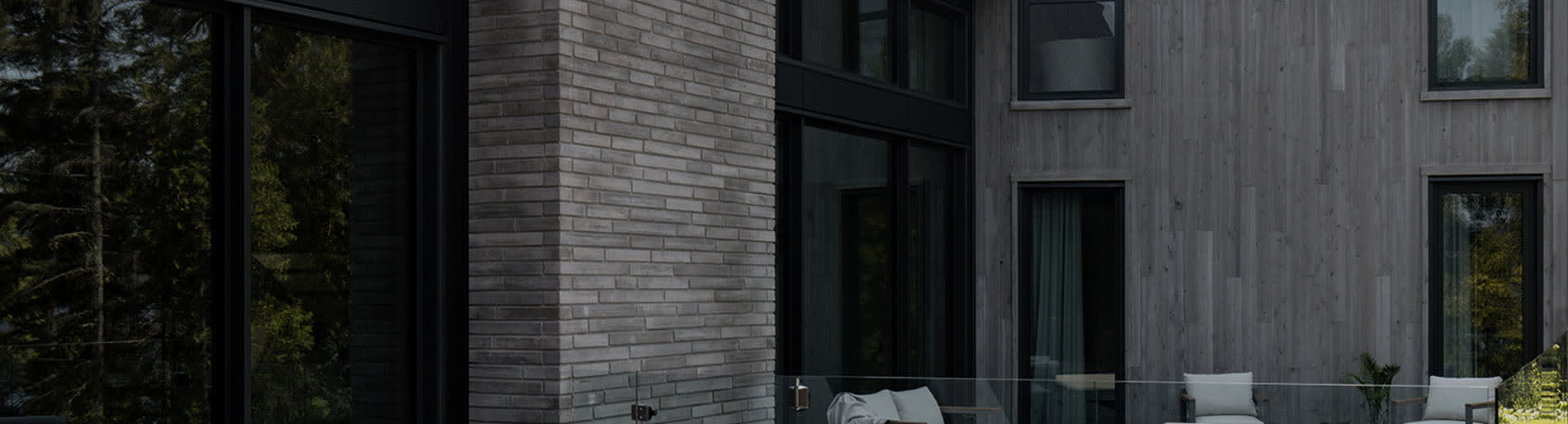 Grey pillar of wall stone on the exterior of a house.