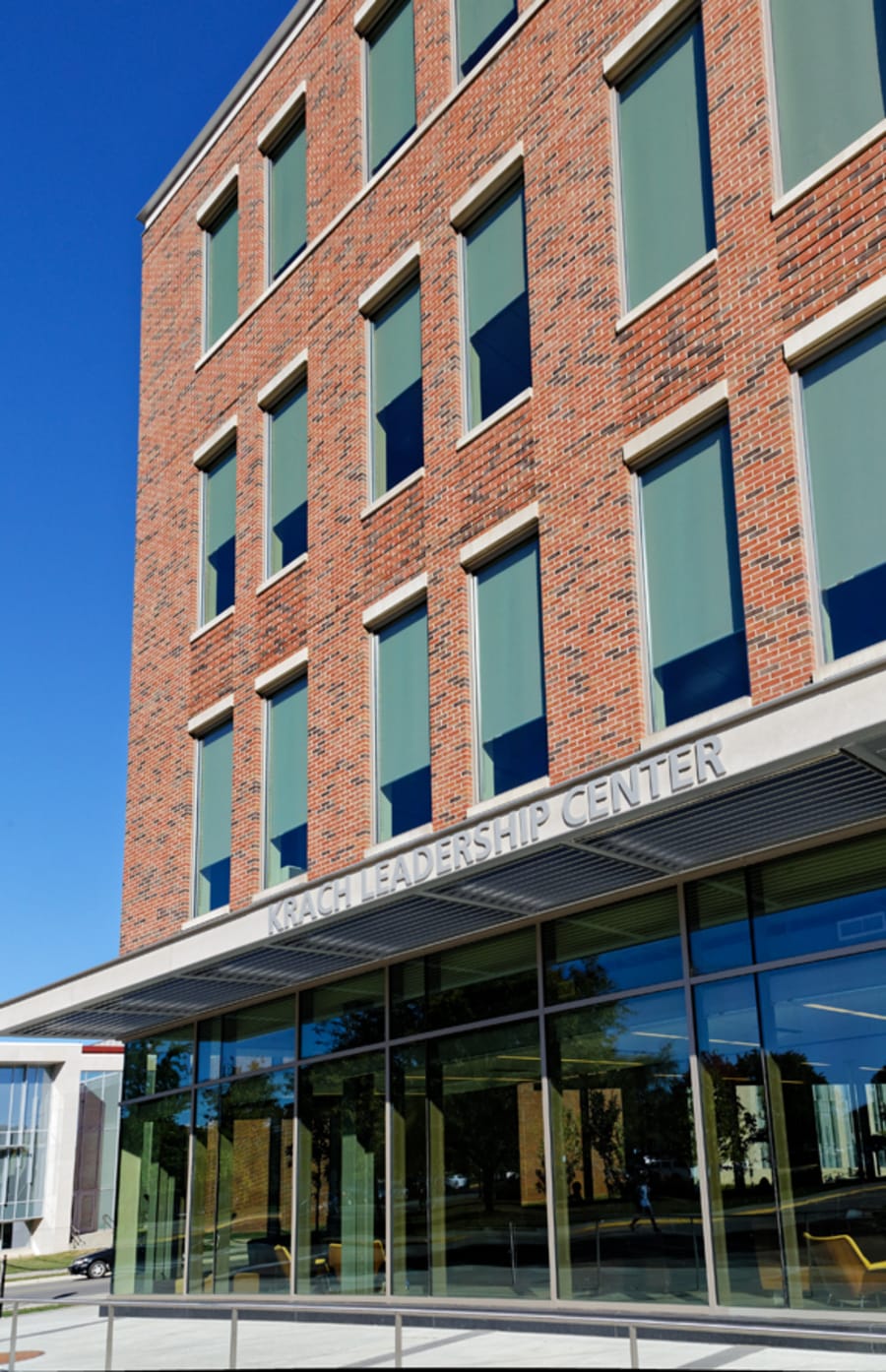 Tall red brick building with sign that reads 'Krach Leadership Center'.