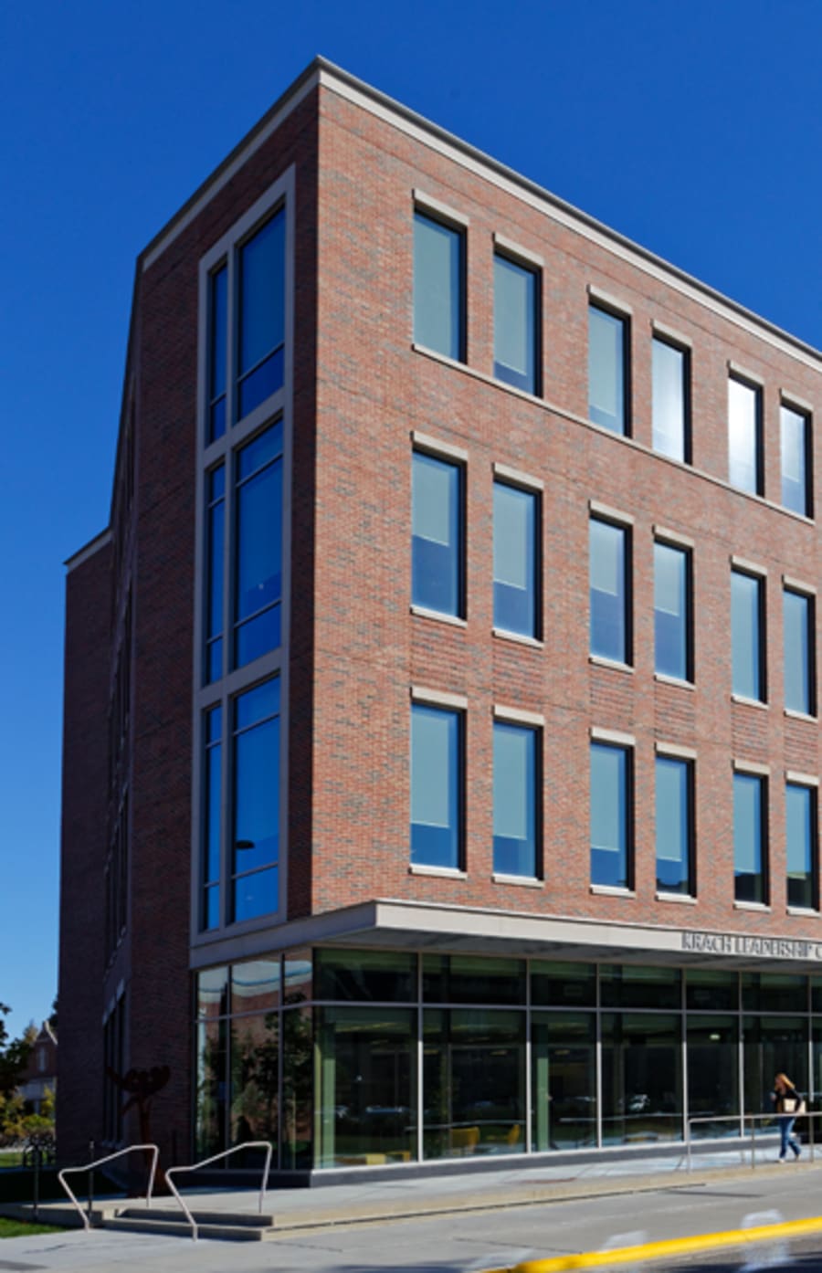 Tall red brick building with sign that reads 'Karach Leadership Center'.