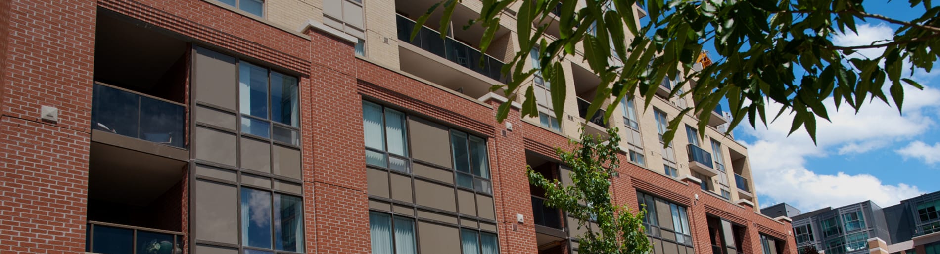 Exterior of large red brick residential building with with balconies.