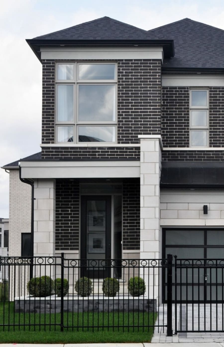 Exterior of two story home with dark grey brick.