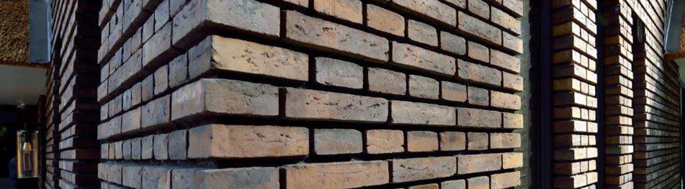 Close up of brown brick corner wall.