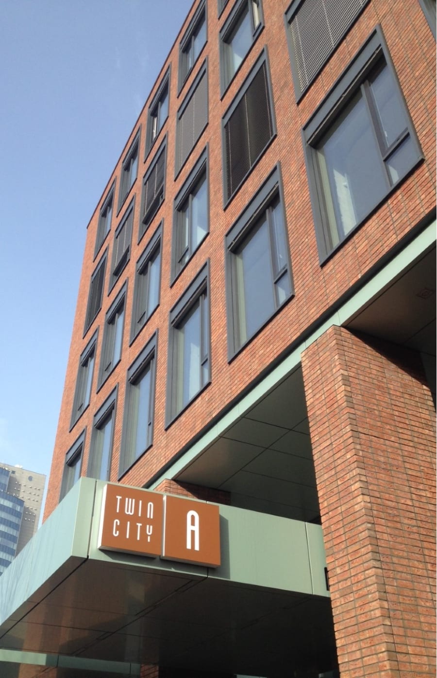 Red brick building with sign that reads 'Twin City A'.