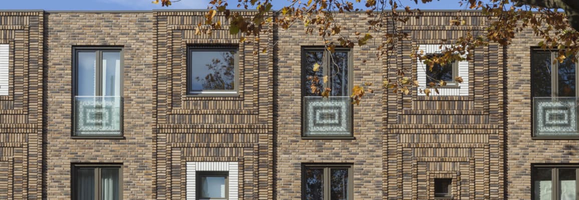 Beige brick building with patterned brick.