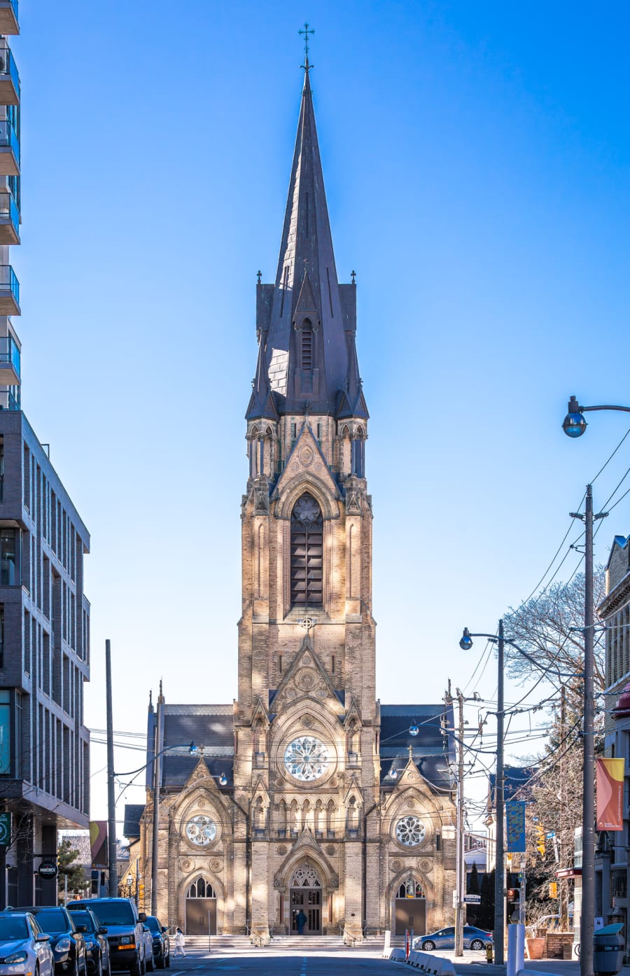 Exterior of St. Mary's Perish church with beige brick and stained glass windows.