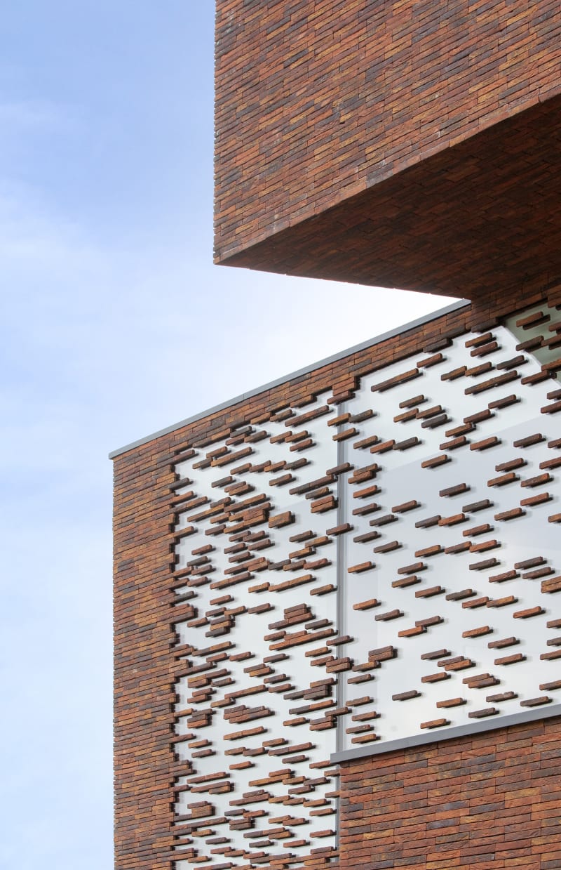 Exterior of a building with patterned red brick.