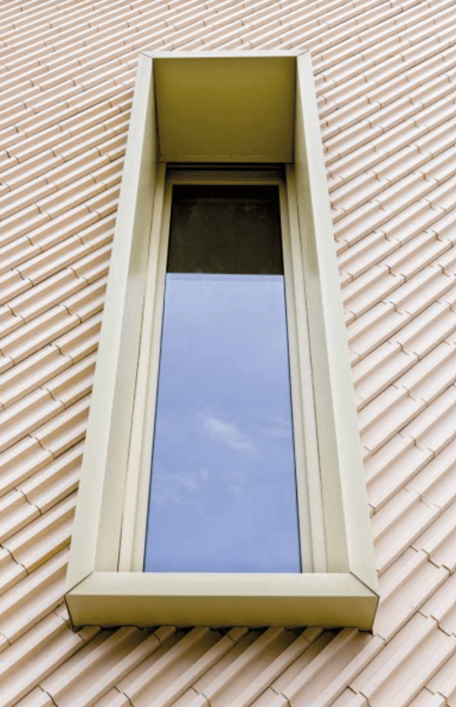 Light beige pattern brick and a large window.