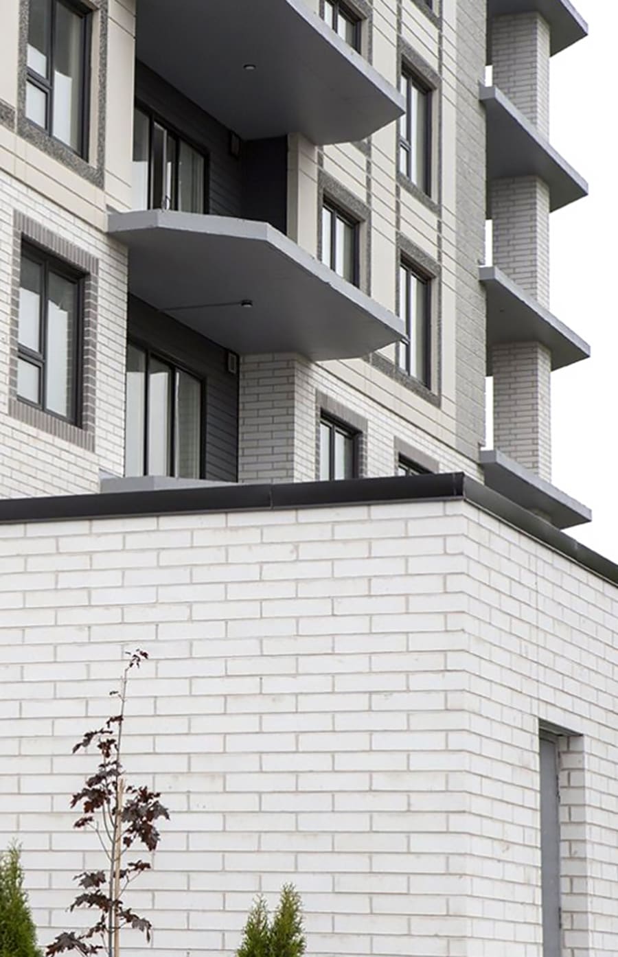 Multi-level building with light grey brick.