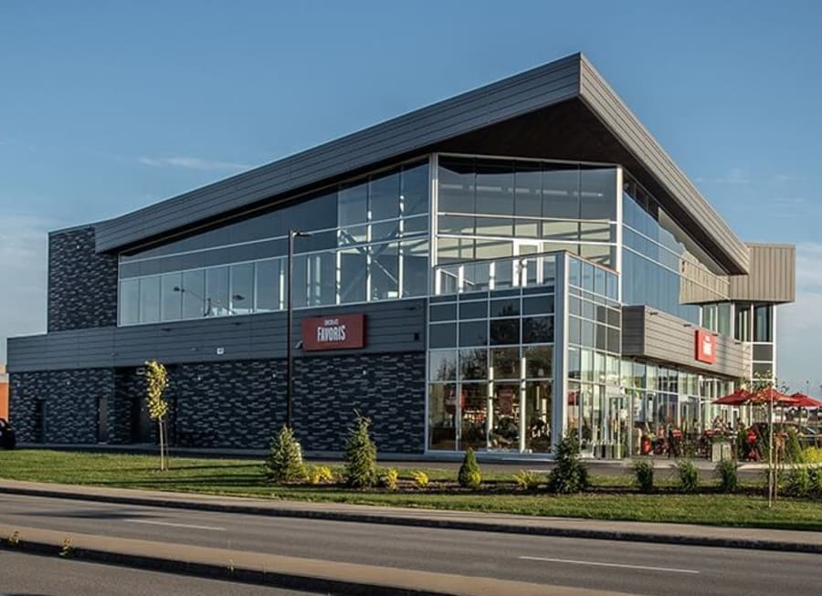 Exterior of a commercial building with black and grey patterned brick.