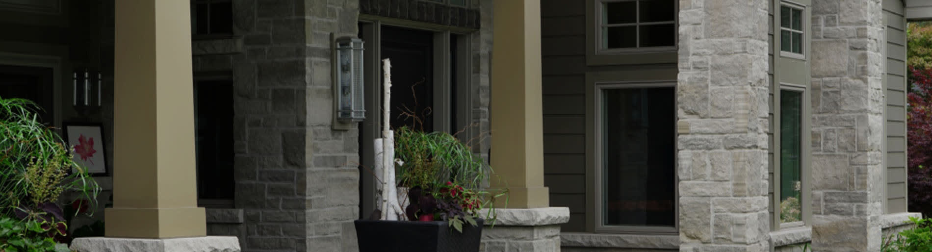 Grey wall stone pillars on the exterior of a house.