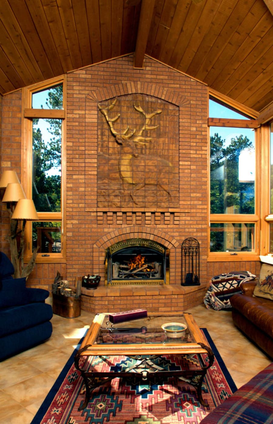 Indoor fireplace with red brick and a custom dear carving in the brick.