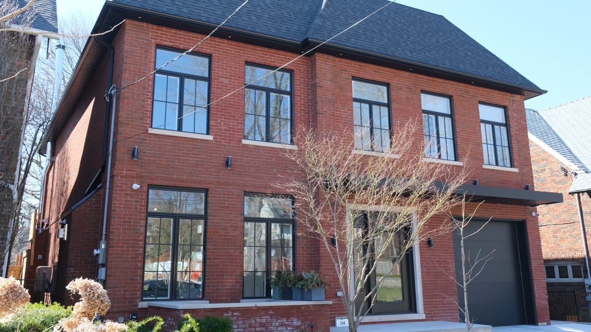 Red brick building with curved archway to the front door.