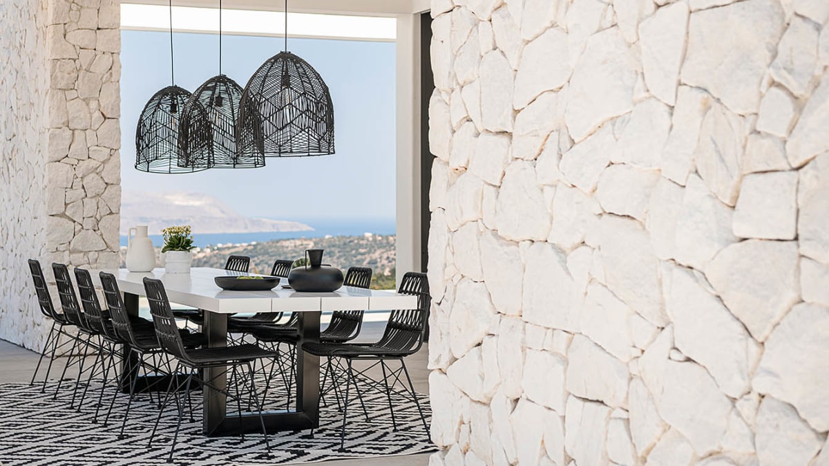 White wall stone with a dining table and chairs.