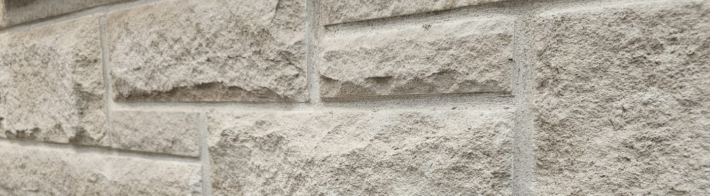 Close up of a limestone brick wall.