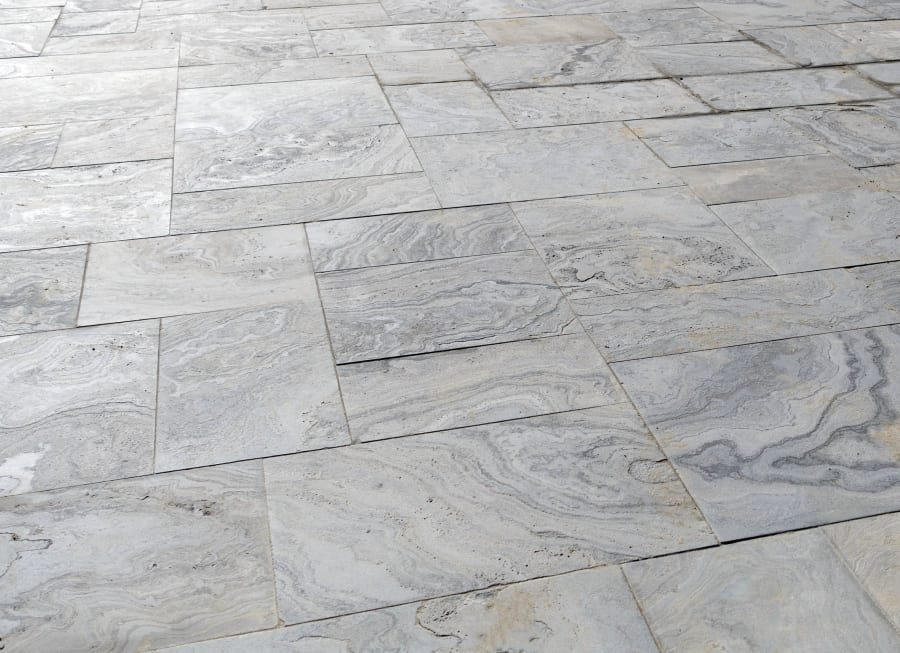 Patio floor with grey pattened pavers and flagstone.