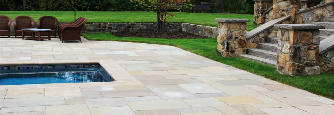 Edge of a pool and stair case with pillars.