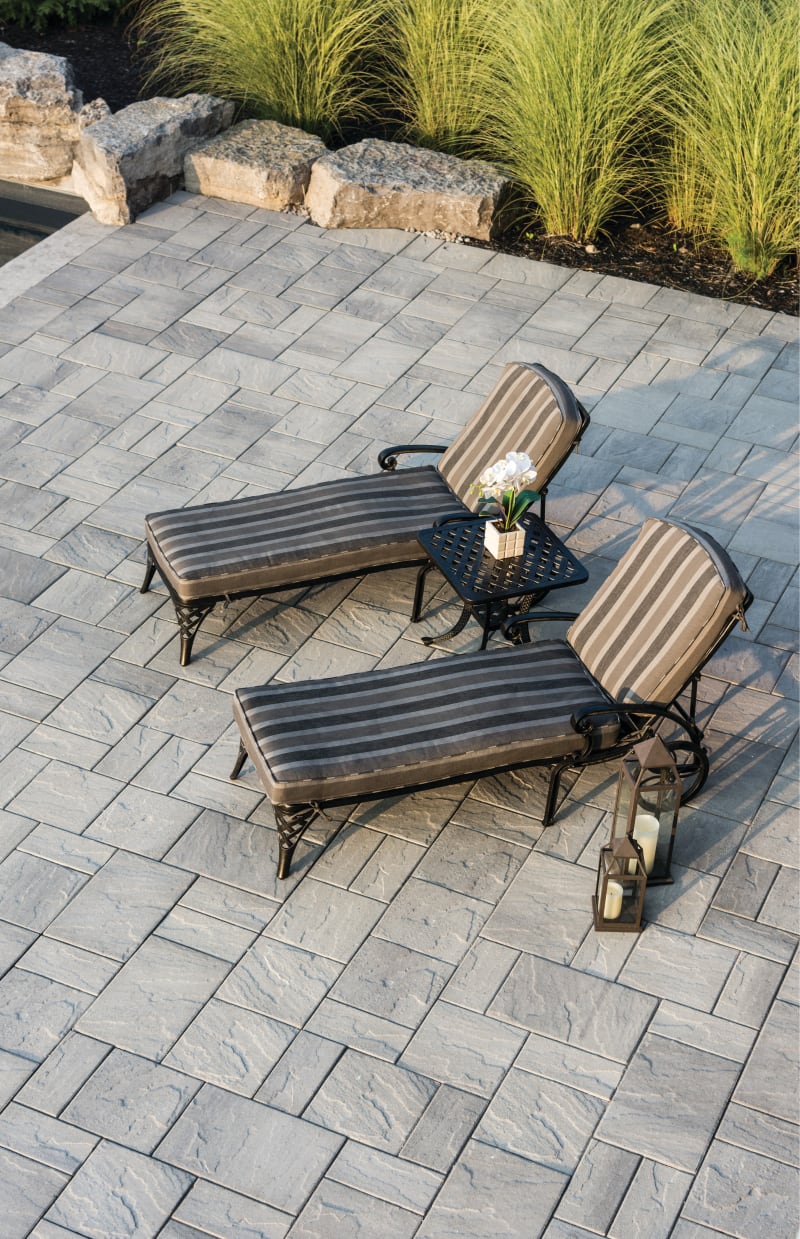 Patio with large grey pavers and flagstone.