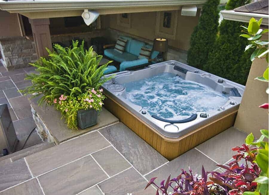 arial shot of hot tub build into outdoor patio made with large pavers