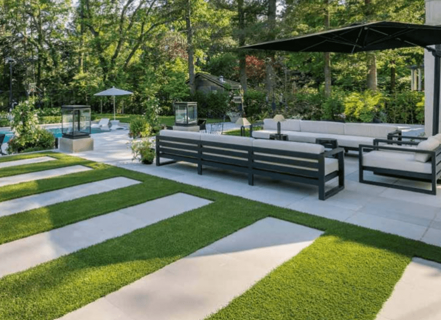 backyard surrounded by trees with large outdoor patio and in-ground pool