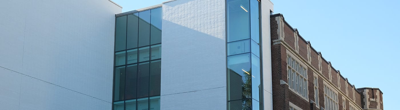 University of Toronto Schools with white brick on one side of the building and red brick on the other side of the building.