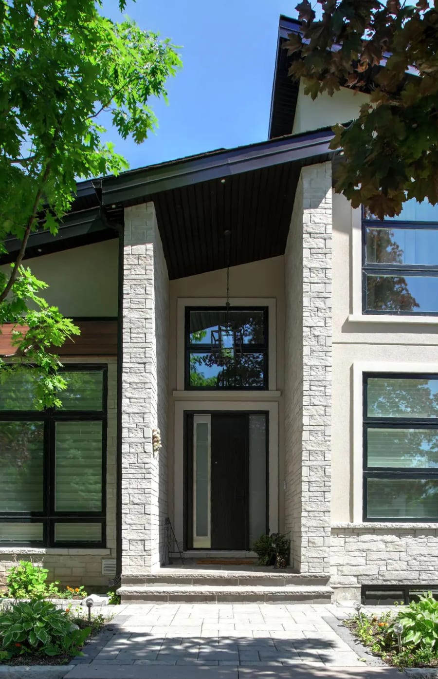 Light grey wall stone pillars on the front of a residential house.