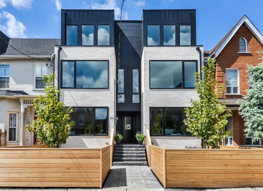 Light grey house with wood fence.