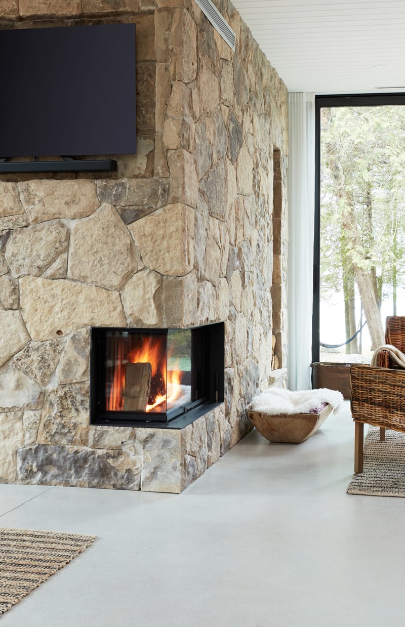 Corner fireplace with beige wall stone.